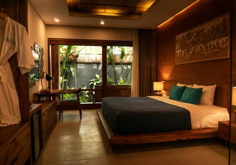 A calm hotel bedroom with a garden view